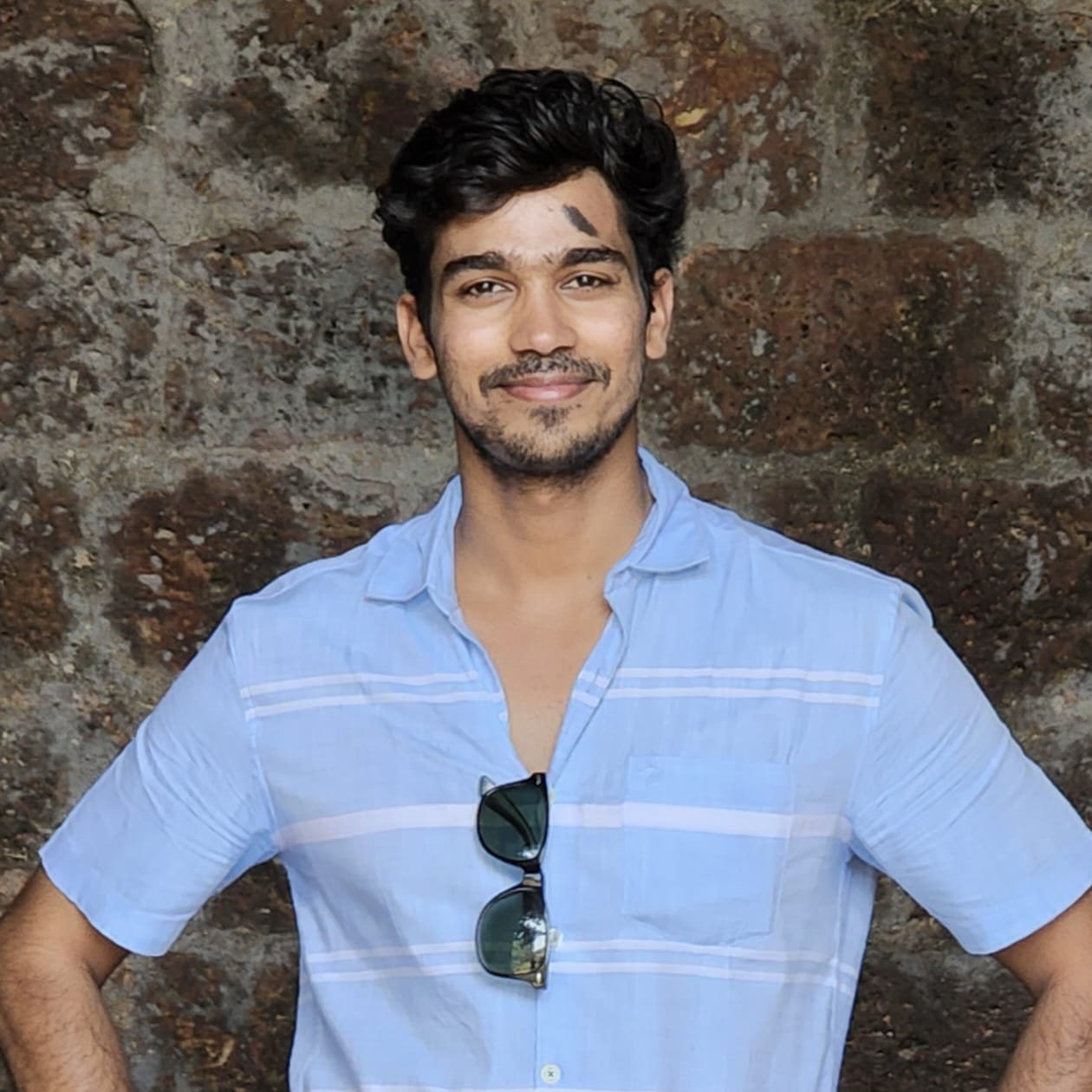 A circular photo of Sumit; links to home.
